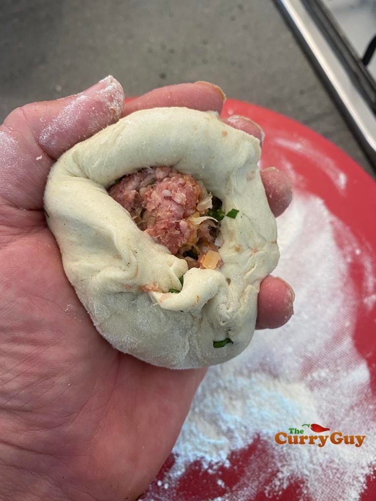 Placing the keema in the dough