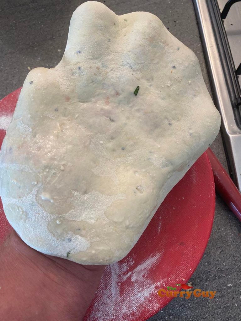 Picking up the naan for cooking.