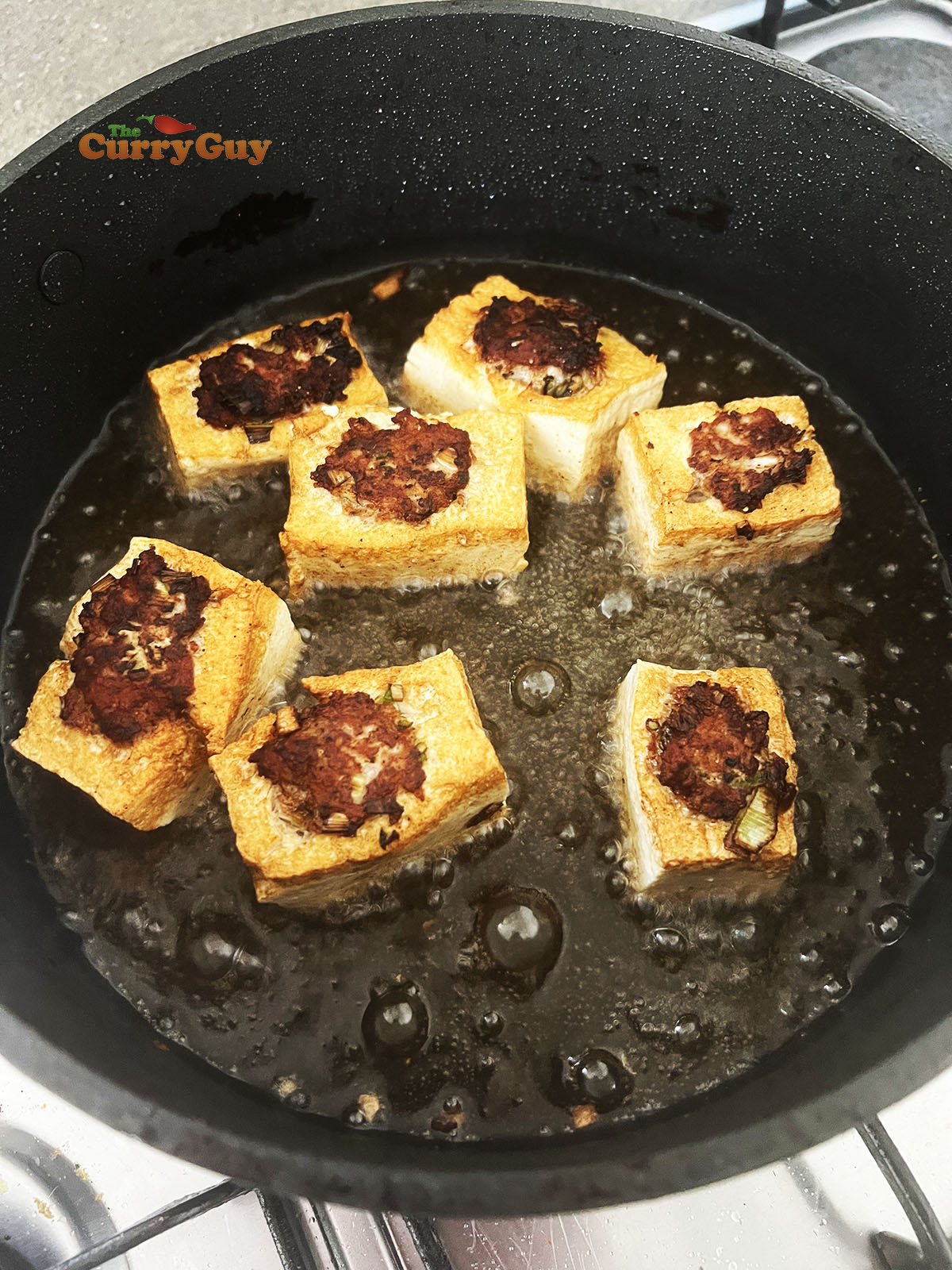 Frying the pork stuffed tofu.