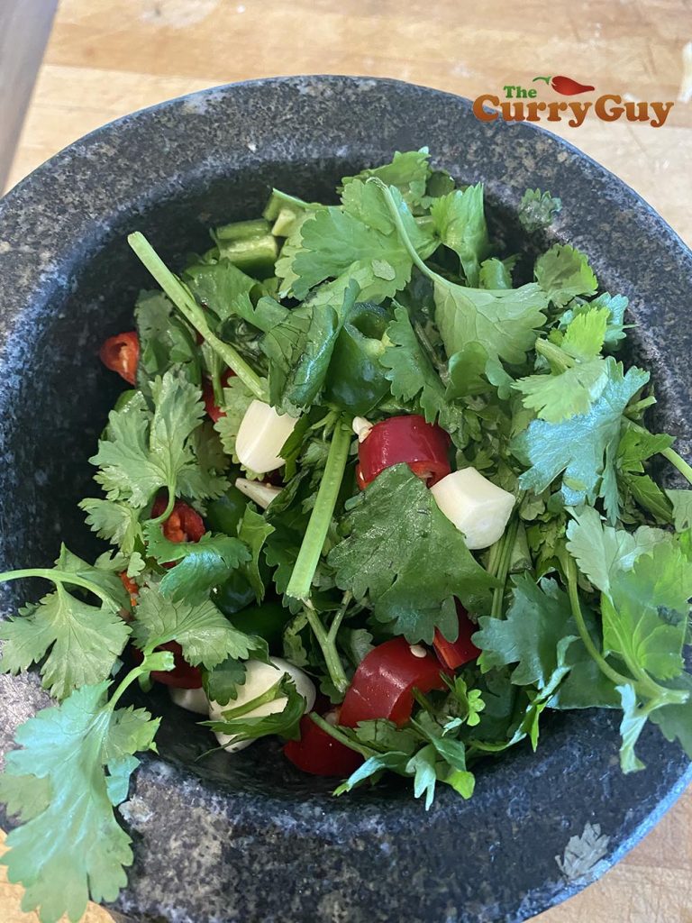 Adding coriander (cilantro) to the paste