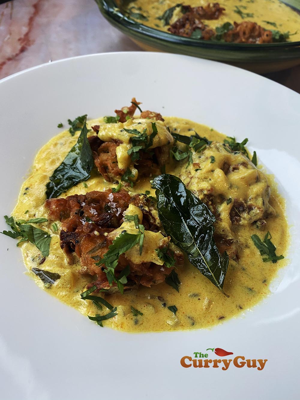 Plating the onion bhaji curry