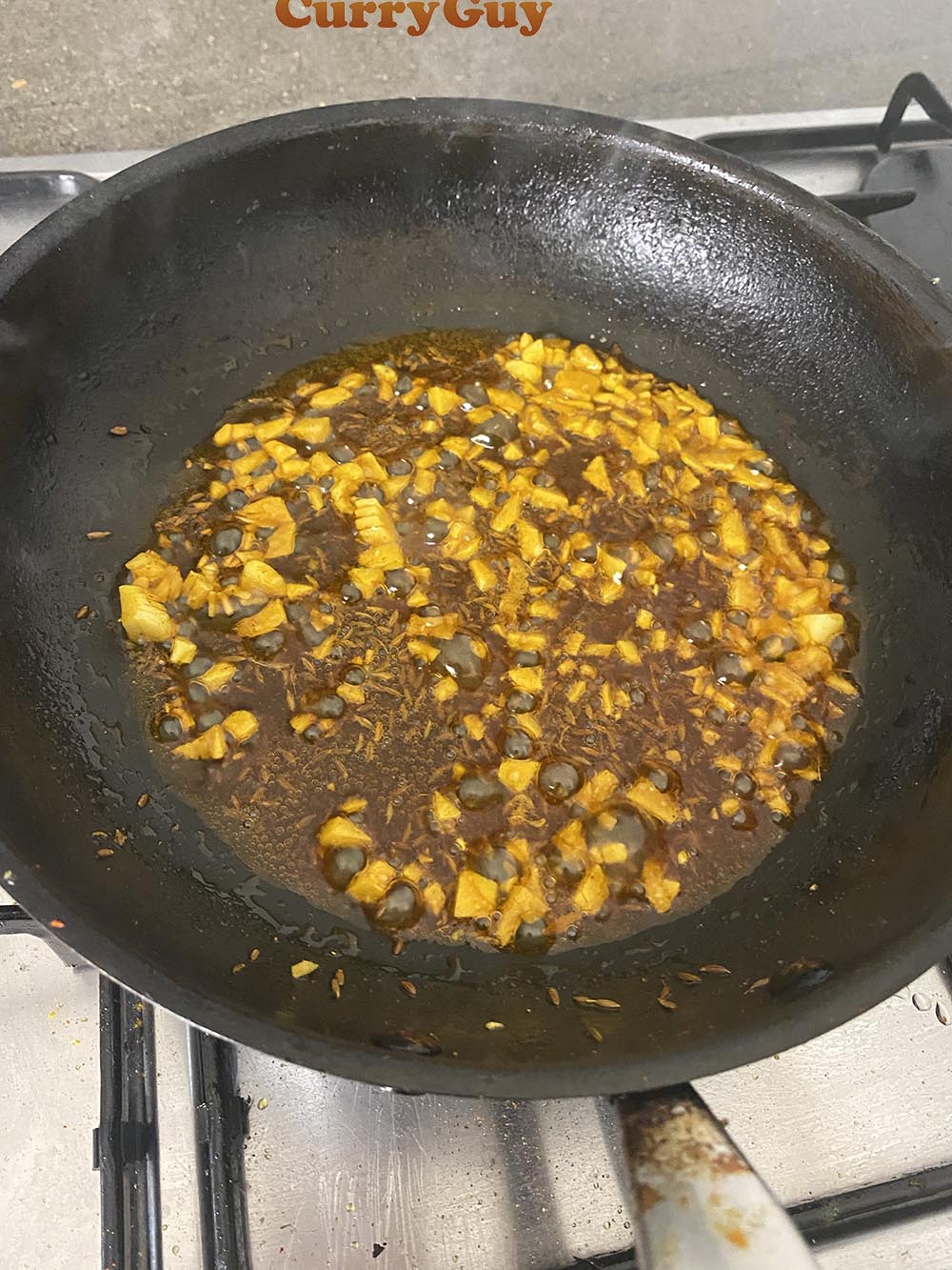 adding garlic to the pan