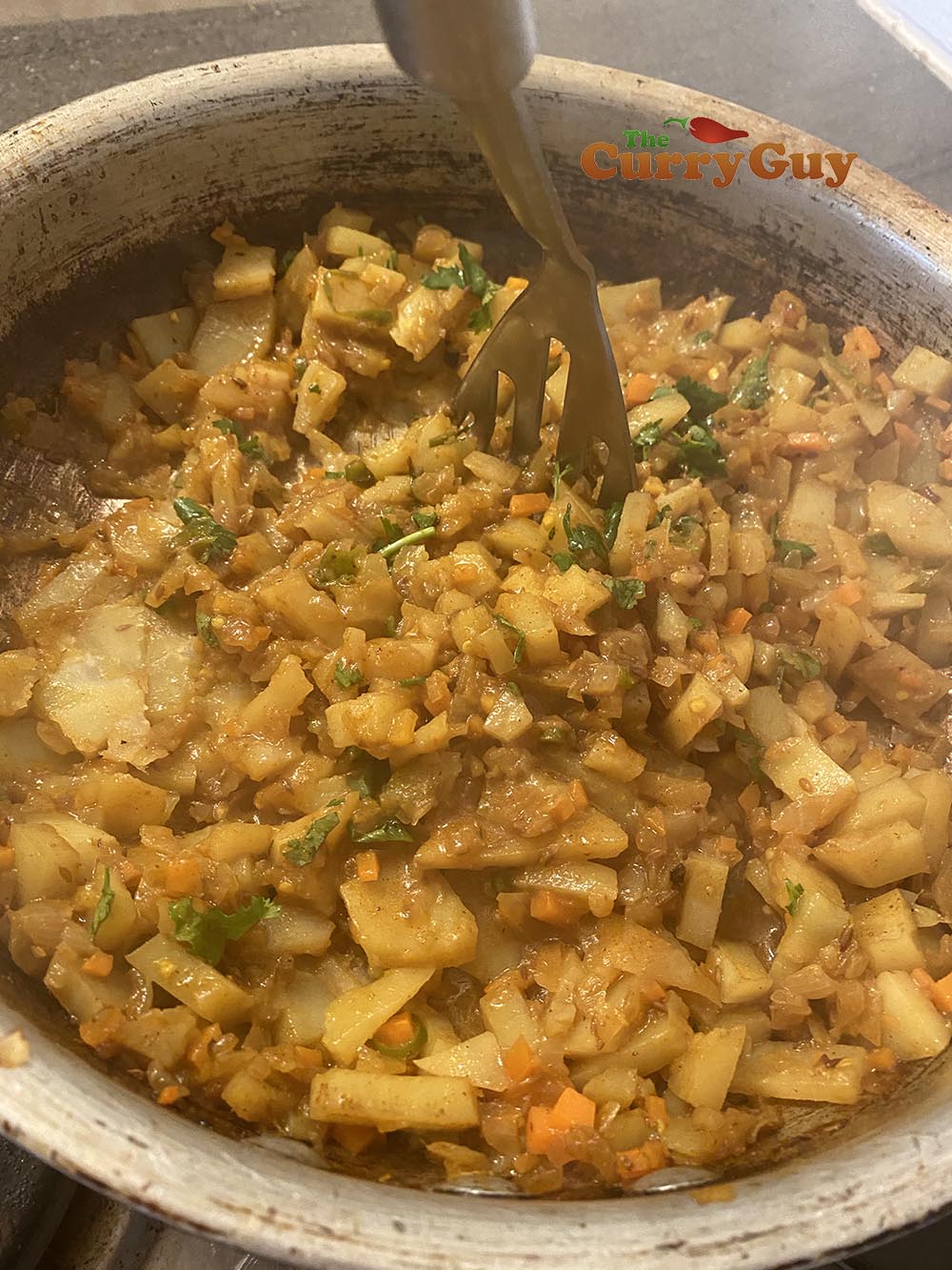 Using potato masher to crush potatoes