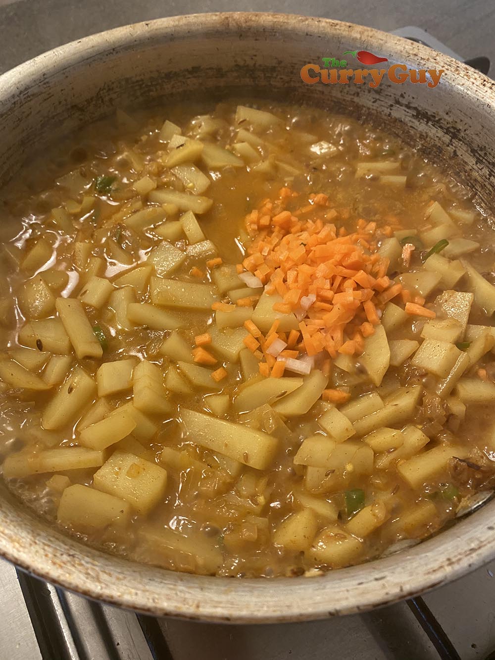 Adding potato and carrots