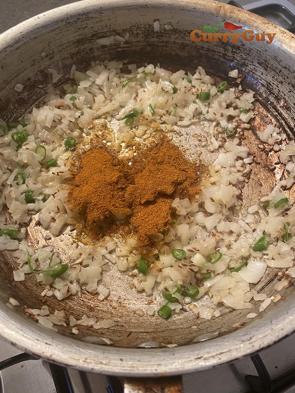Adding ground spices to the onions