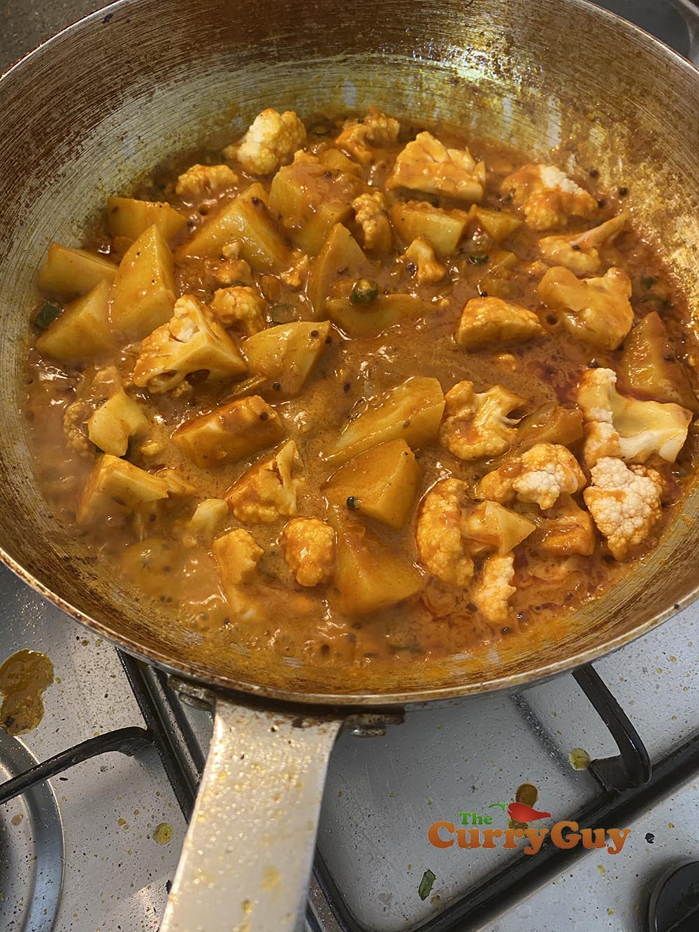 Adding par-cooked potatoes and cauliflower.