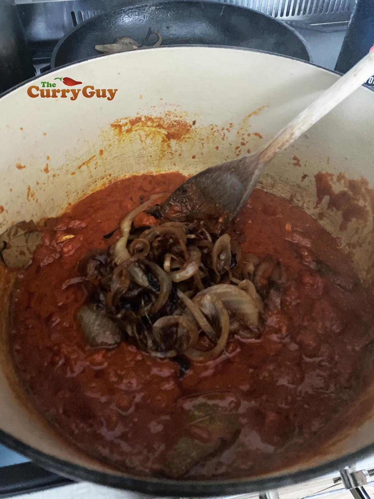 Adding fried onions to the pan