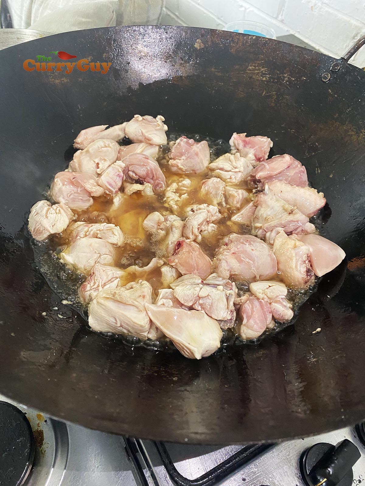 Adding chicken to the hot fat