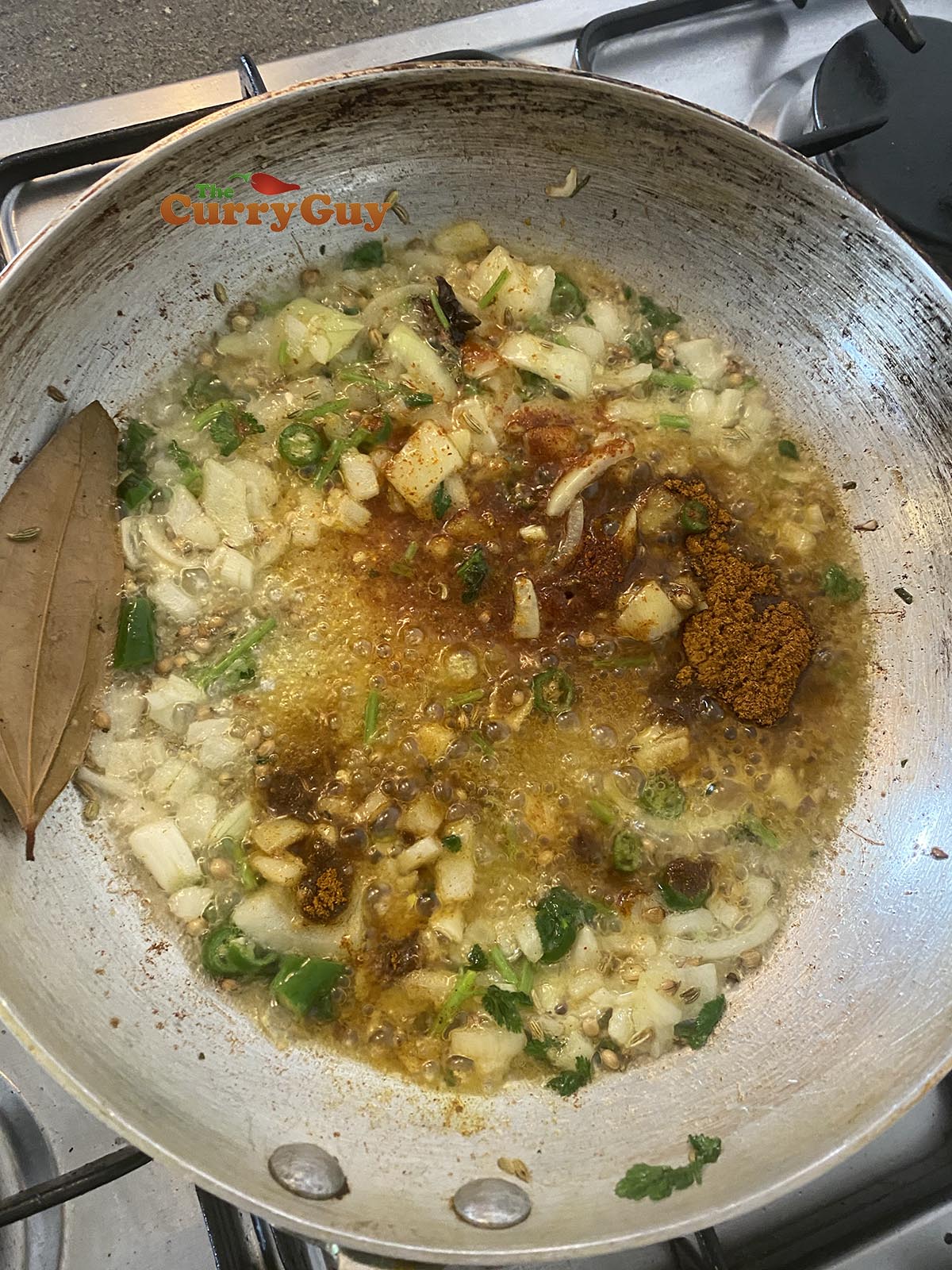 Adding ground spices to pan.