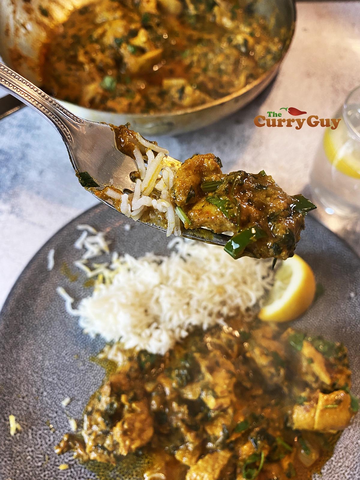 Chicken methi curry on a fork. 