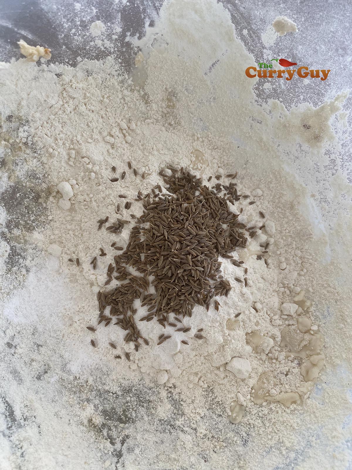 Adding cumin to papad flour