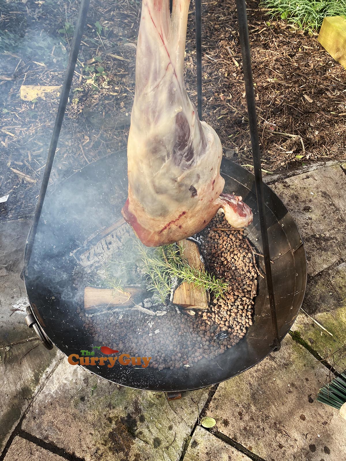 lamb leg smoking over fire
