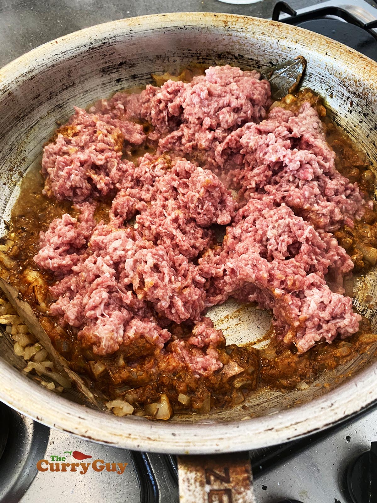 adding meat to the pan