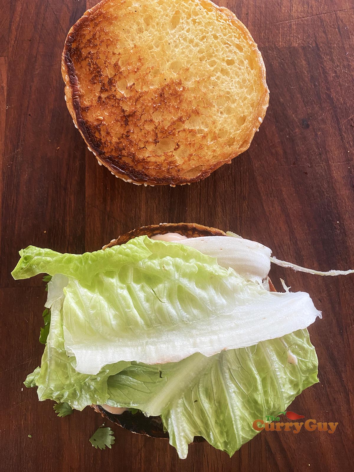 Adding lettuce to burger