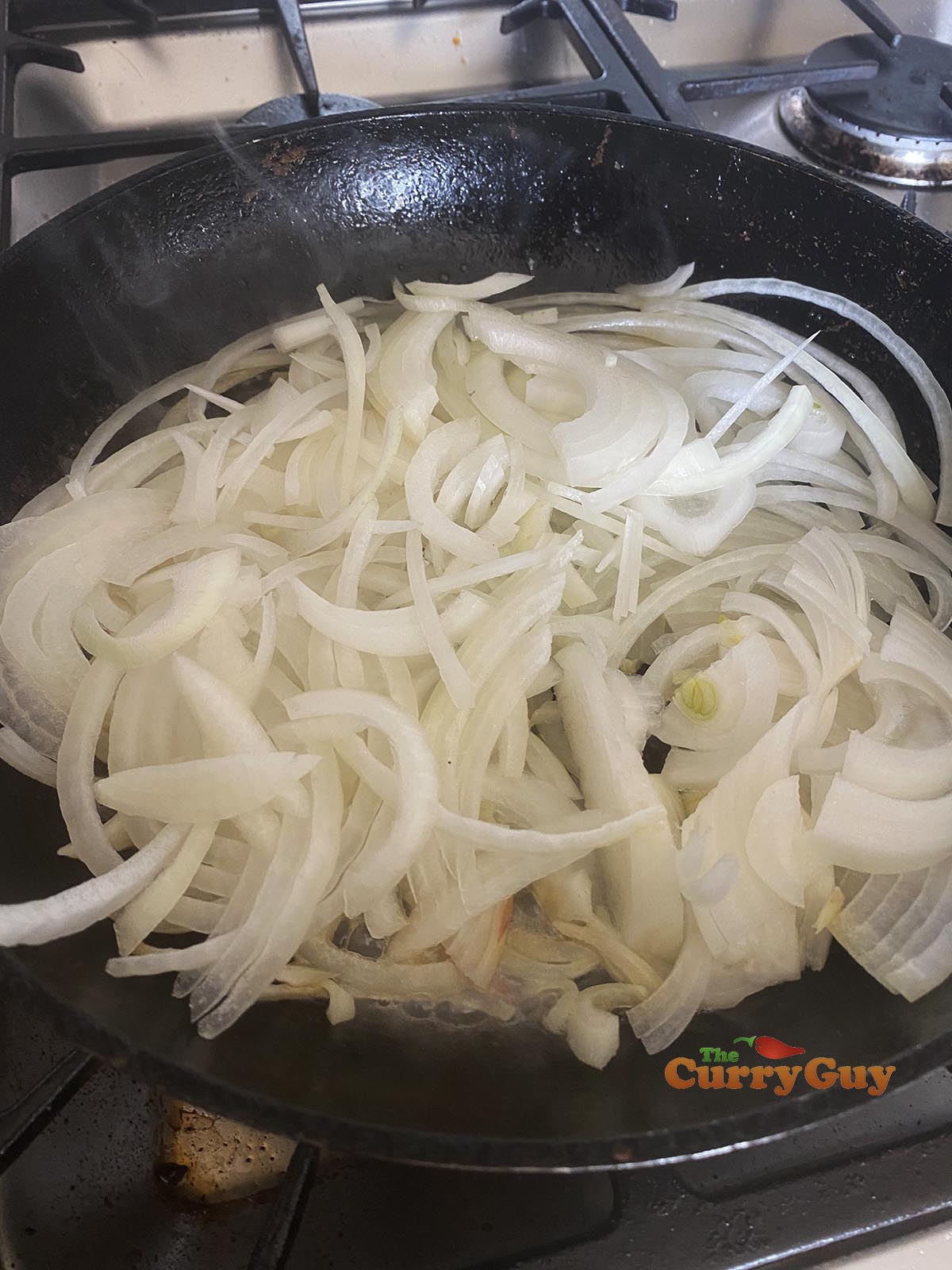 Raw onions in pan
