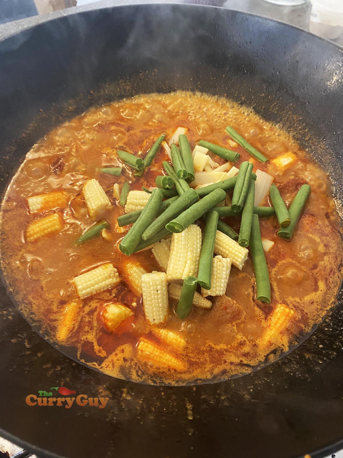Adding vegetables to pan