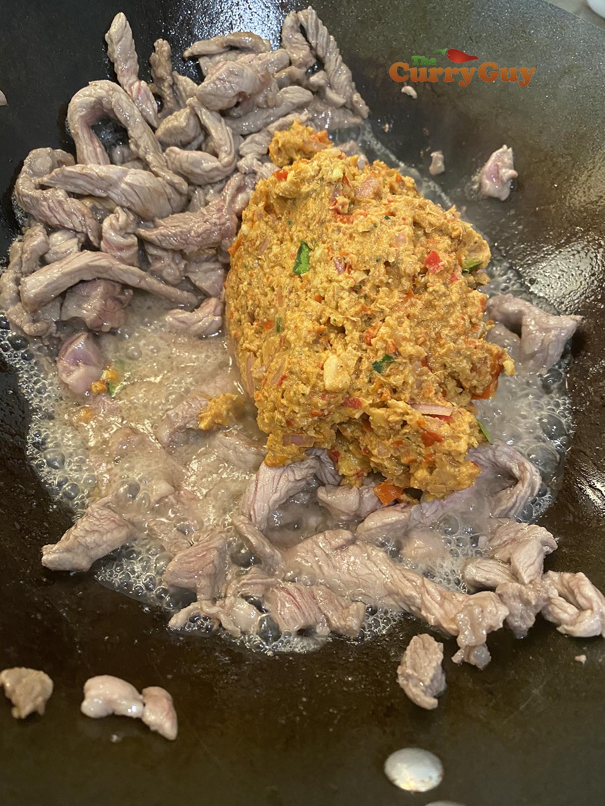 Adding curry paste to pan