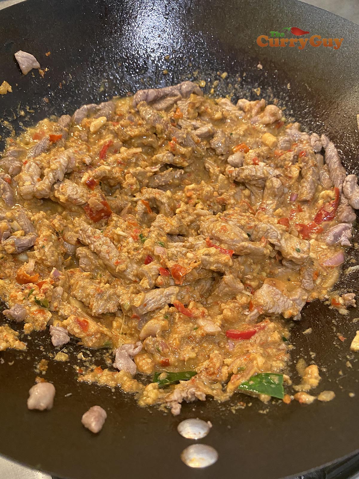 Stirring paste into the meat