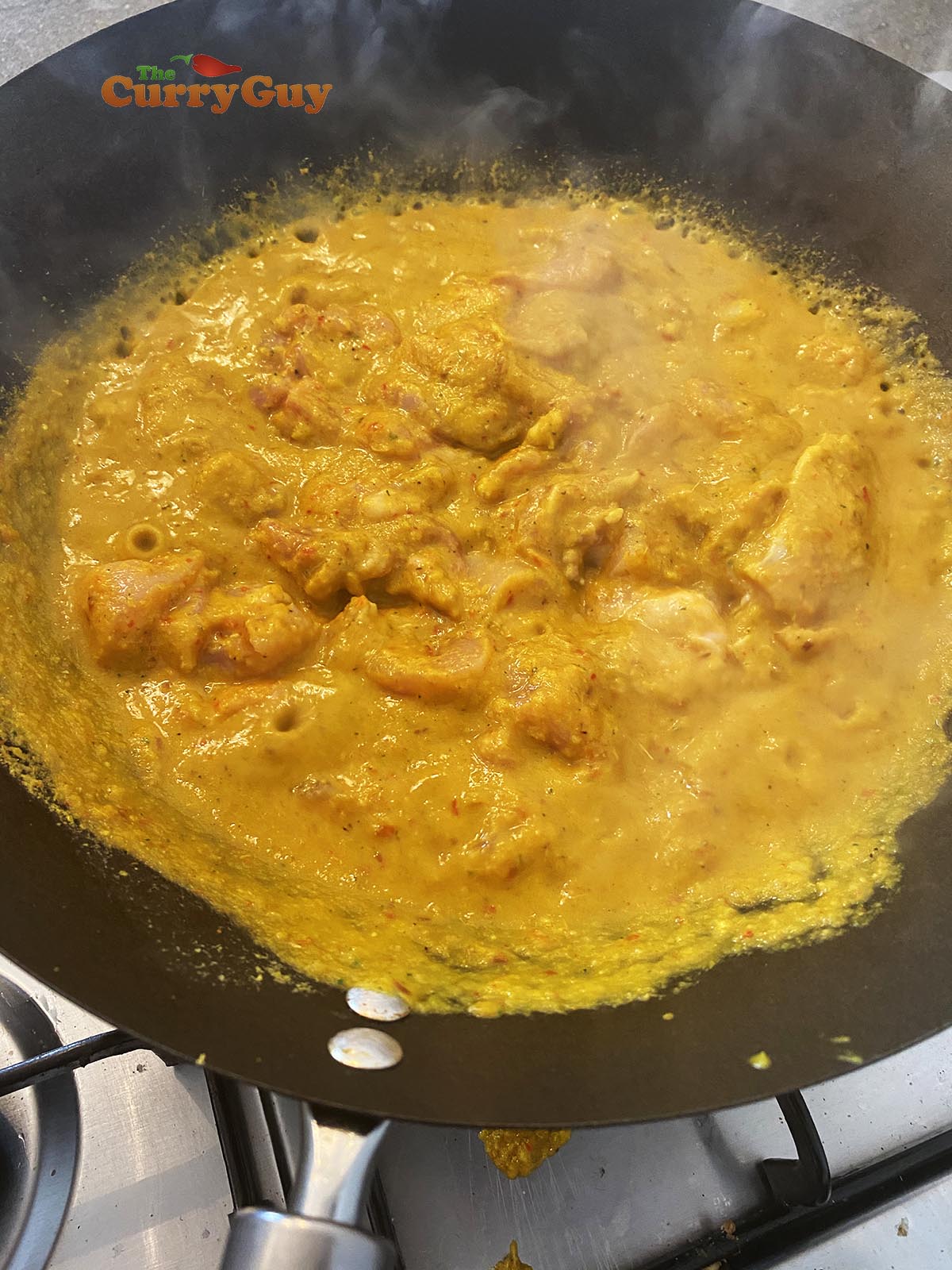 Chicken simmering in thai yellow curry, about 50% complete
