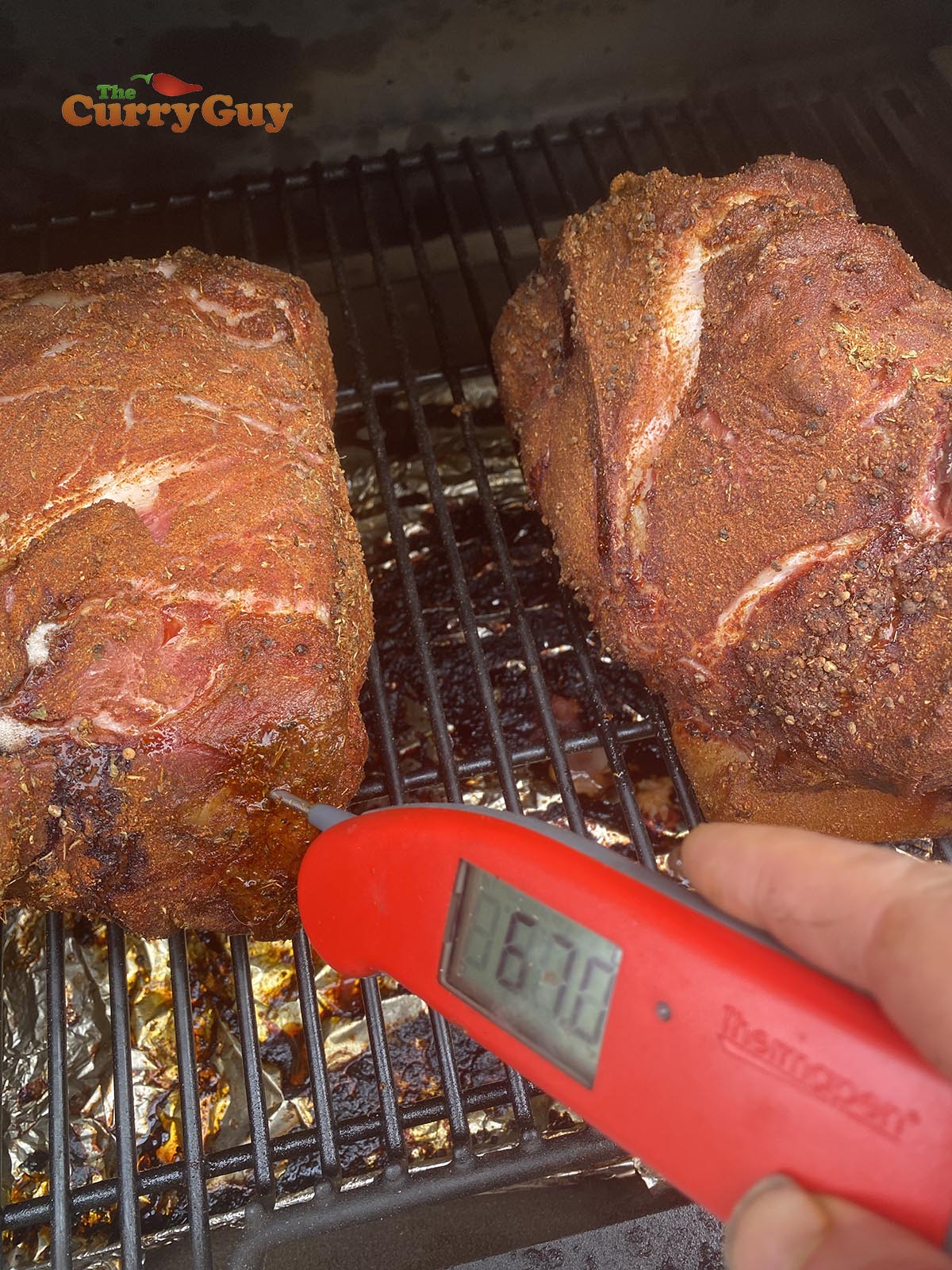 checking temperature of pork butt