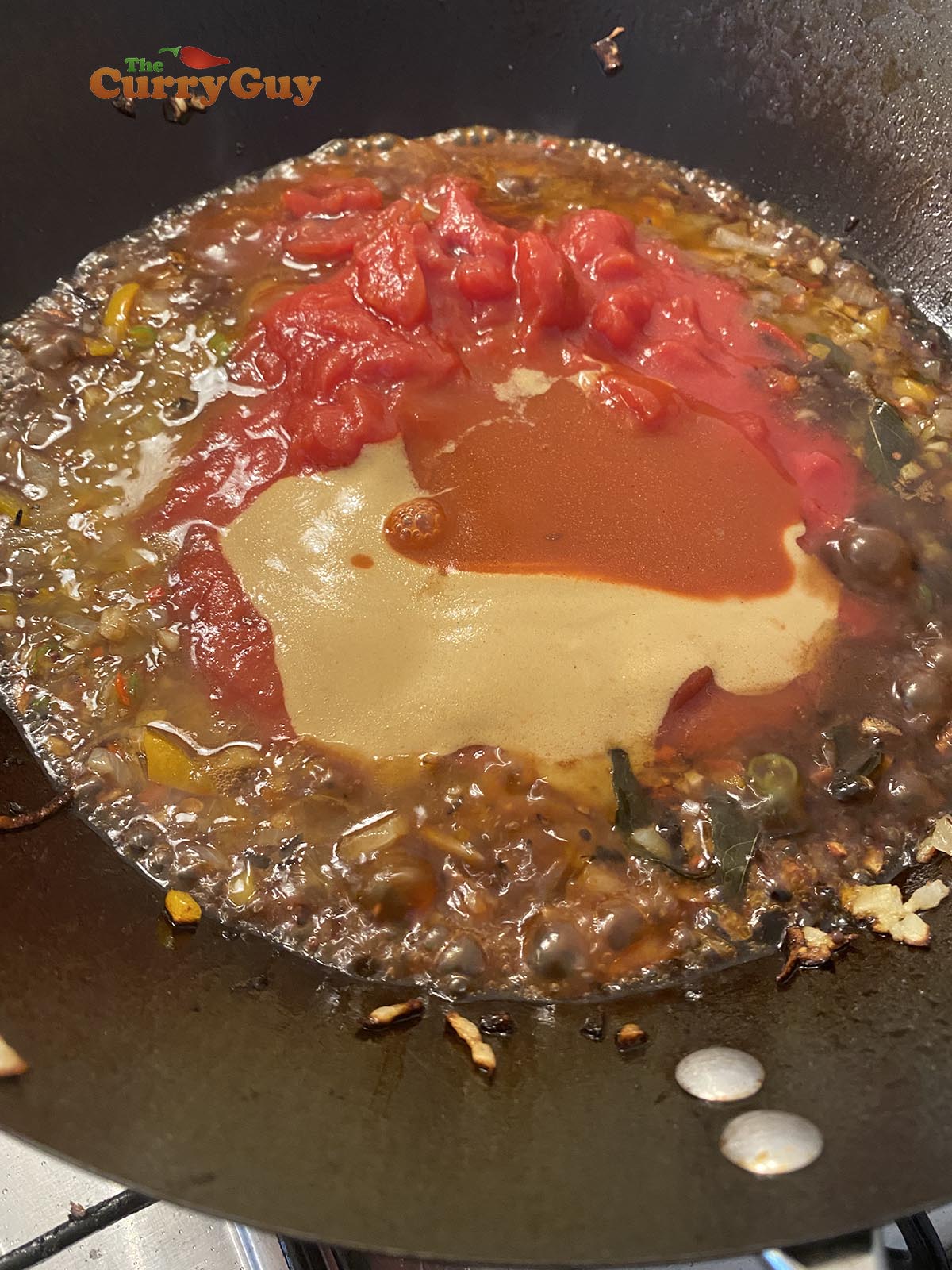 adding mustard and ketchup to sauce