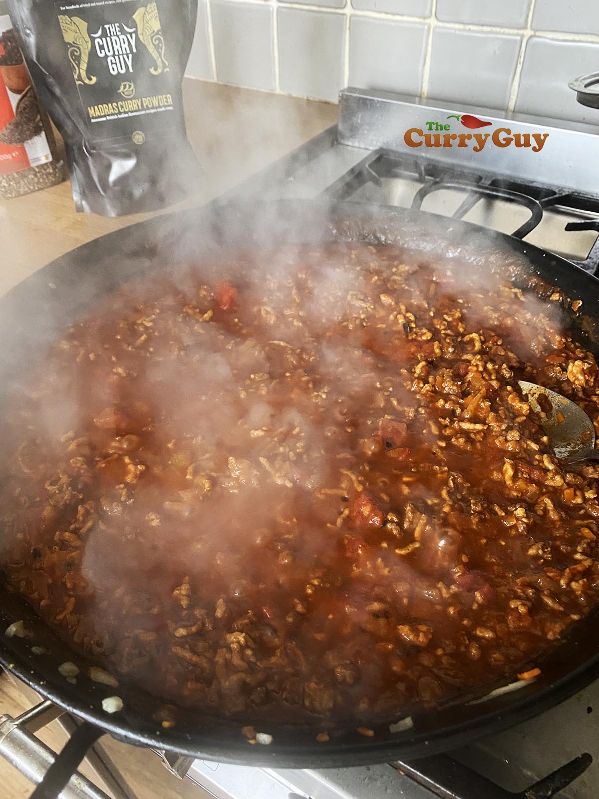 Adding stock and simmering the sauce.