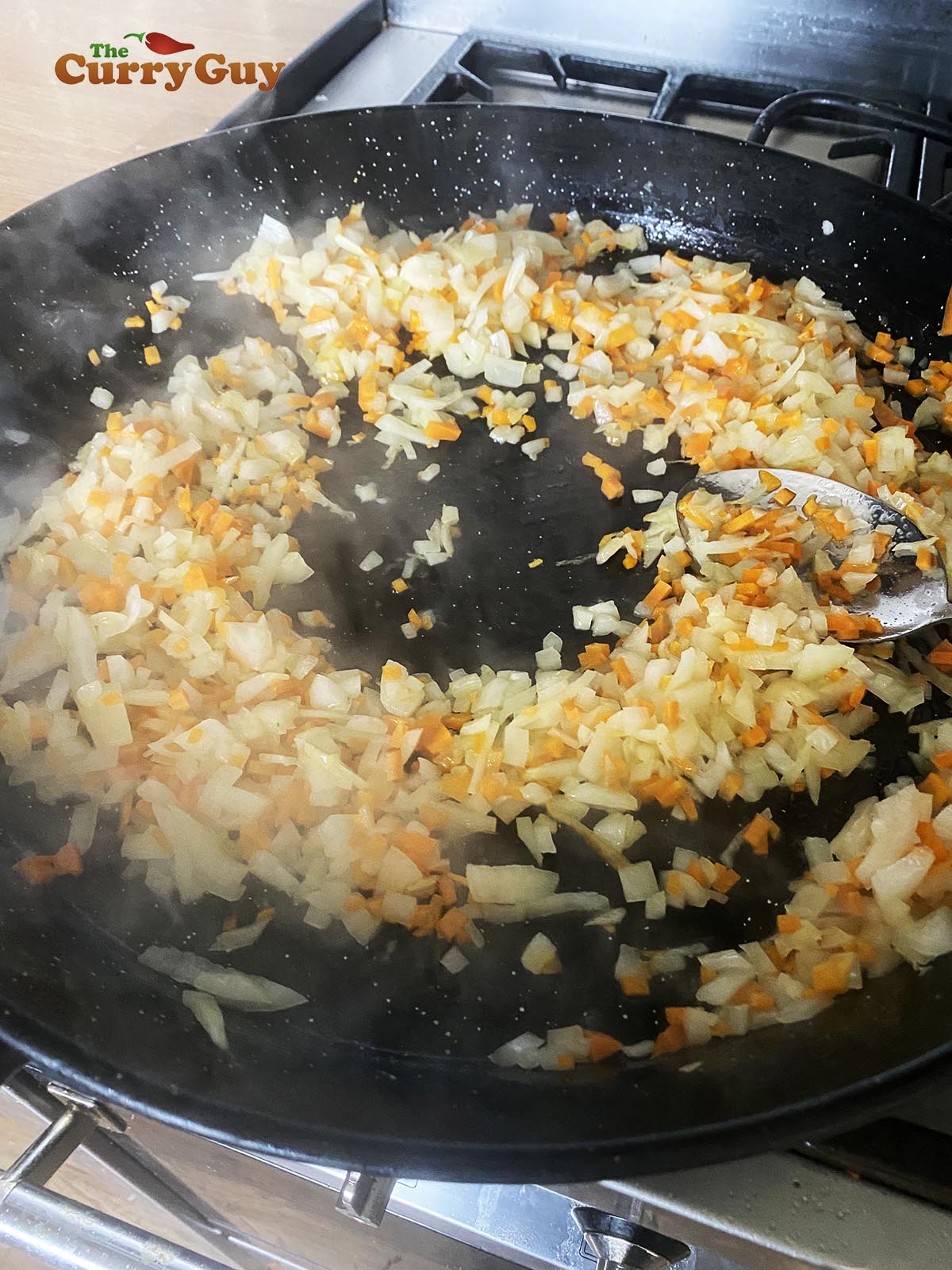 Frying the chopped onions, carrots and mushrooms in the butter.