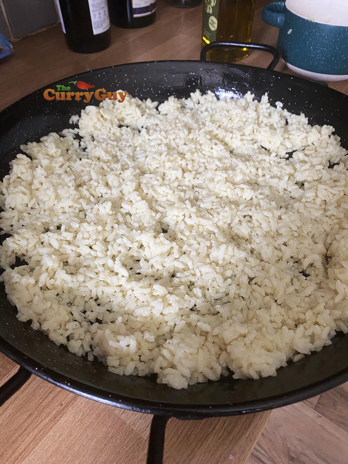 Cooked rice in a lining the bottom of a pan