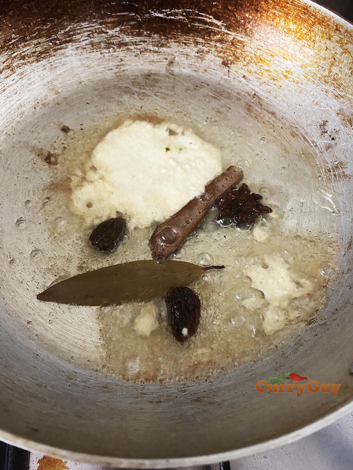 Adding spices, garlic and ginger to pan