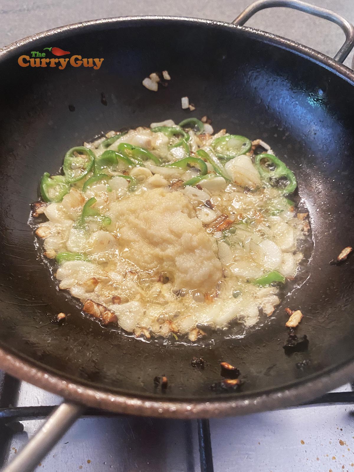 Adding garlic and ginger paste to pan