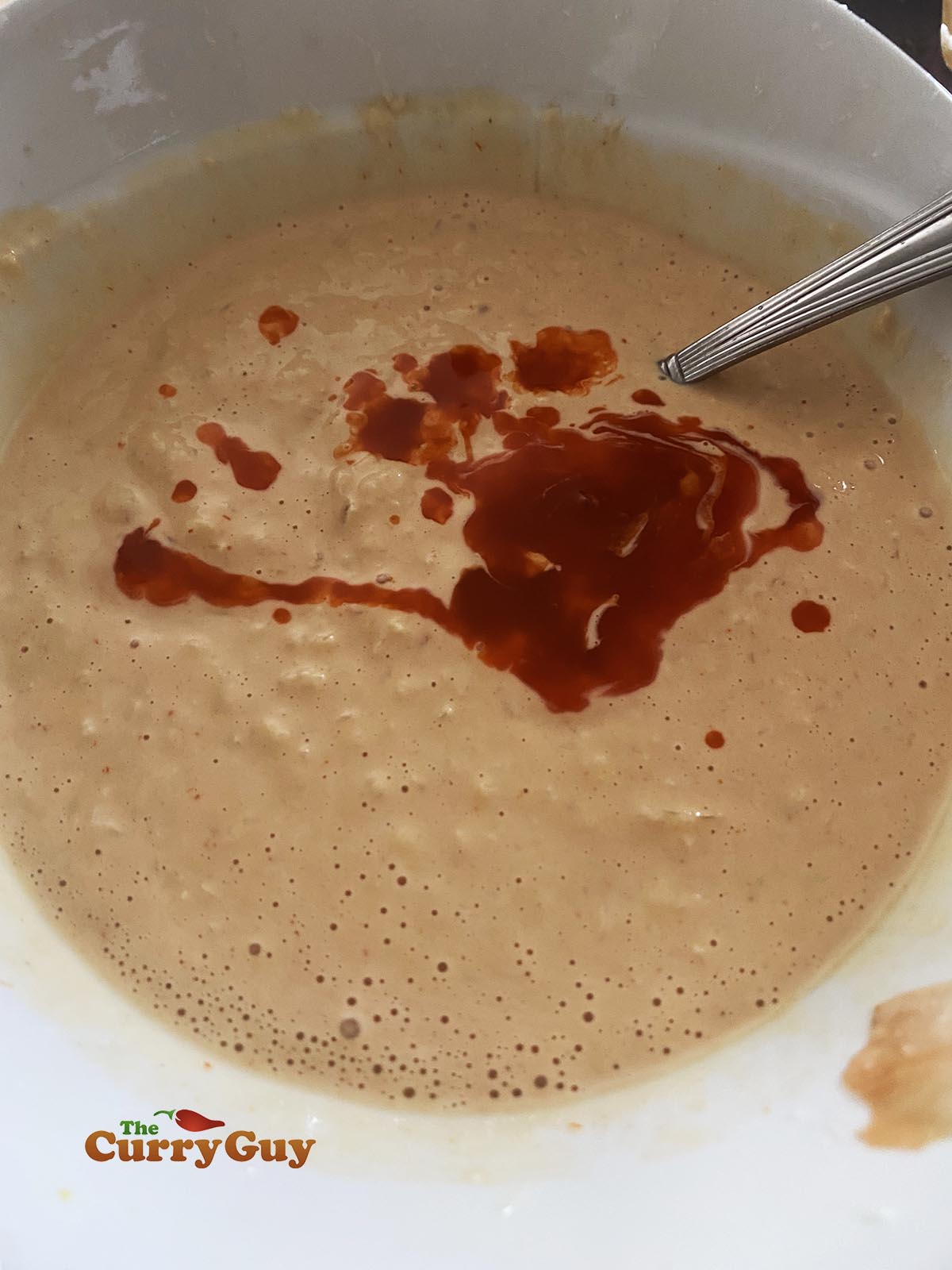 Mixing burger sauce. 