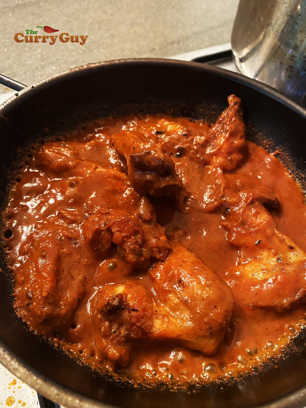 Adding chicken to the pan.