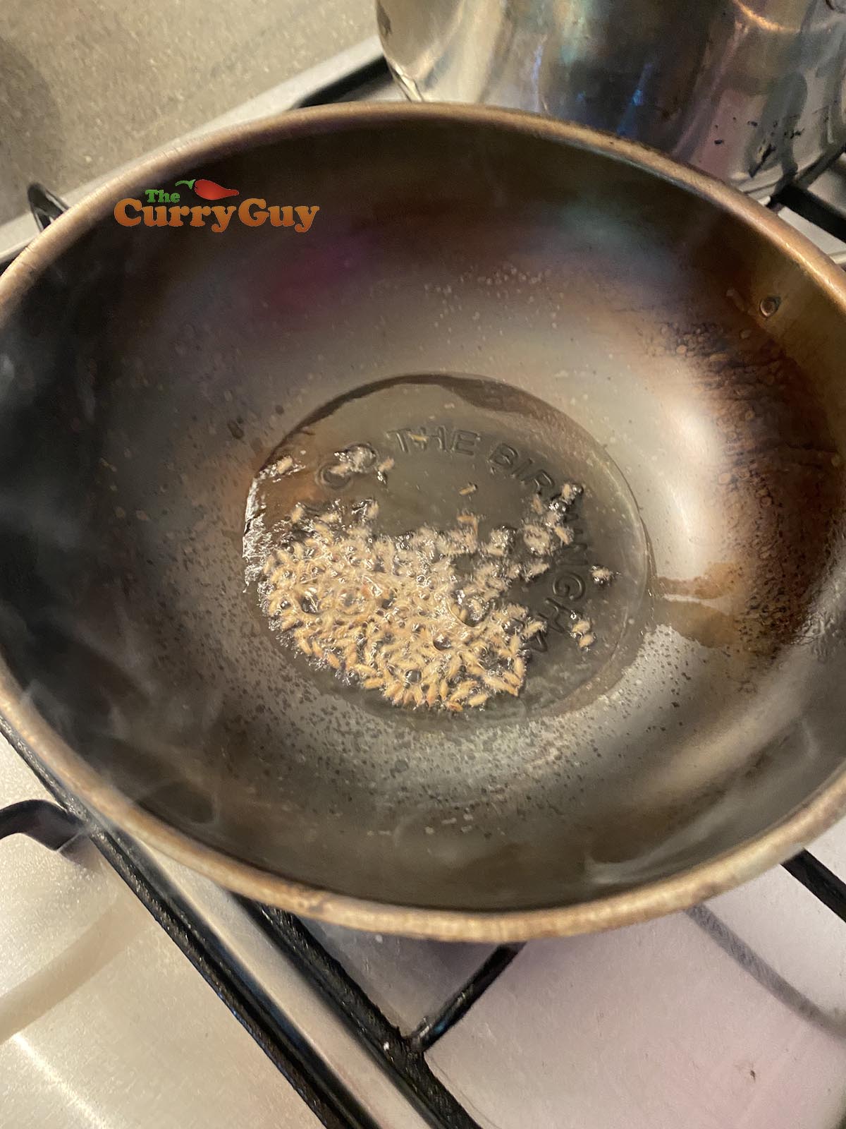 Heating oil and cumin seeds