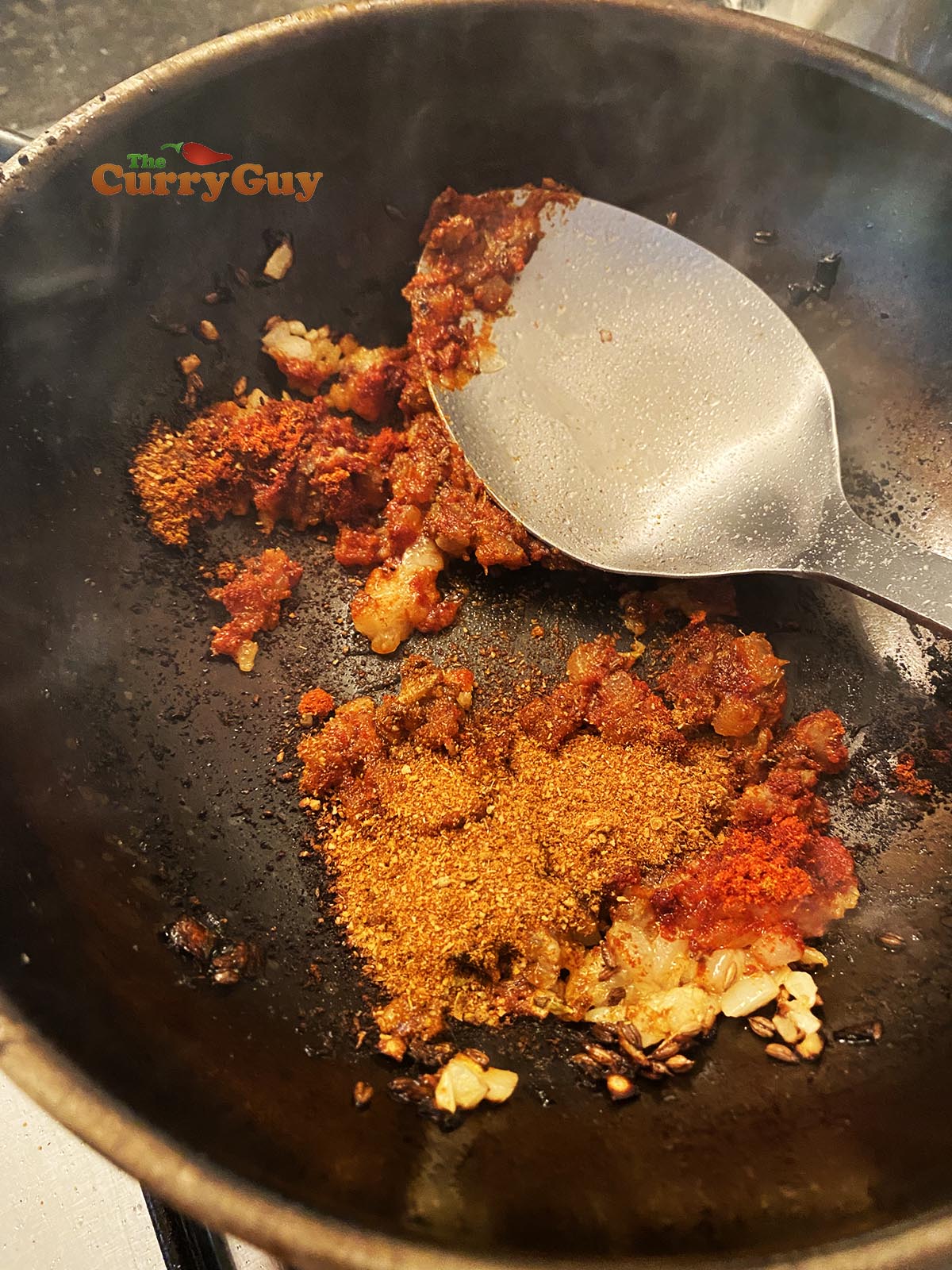 Adding ground spices to pan