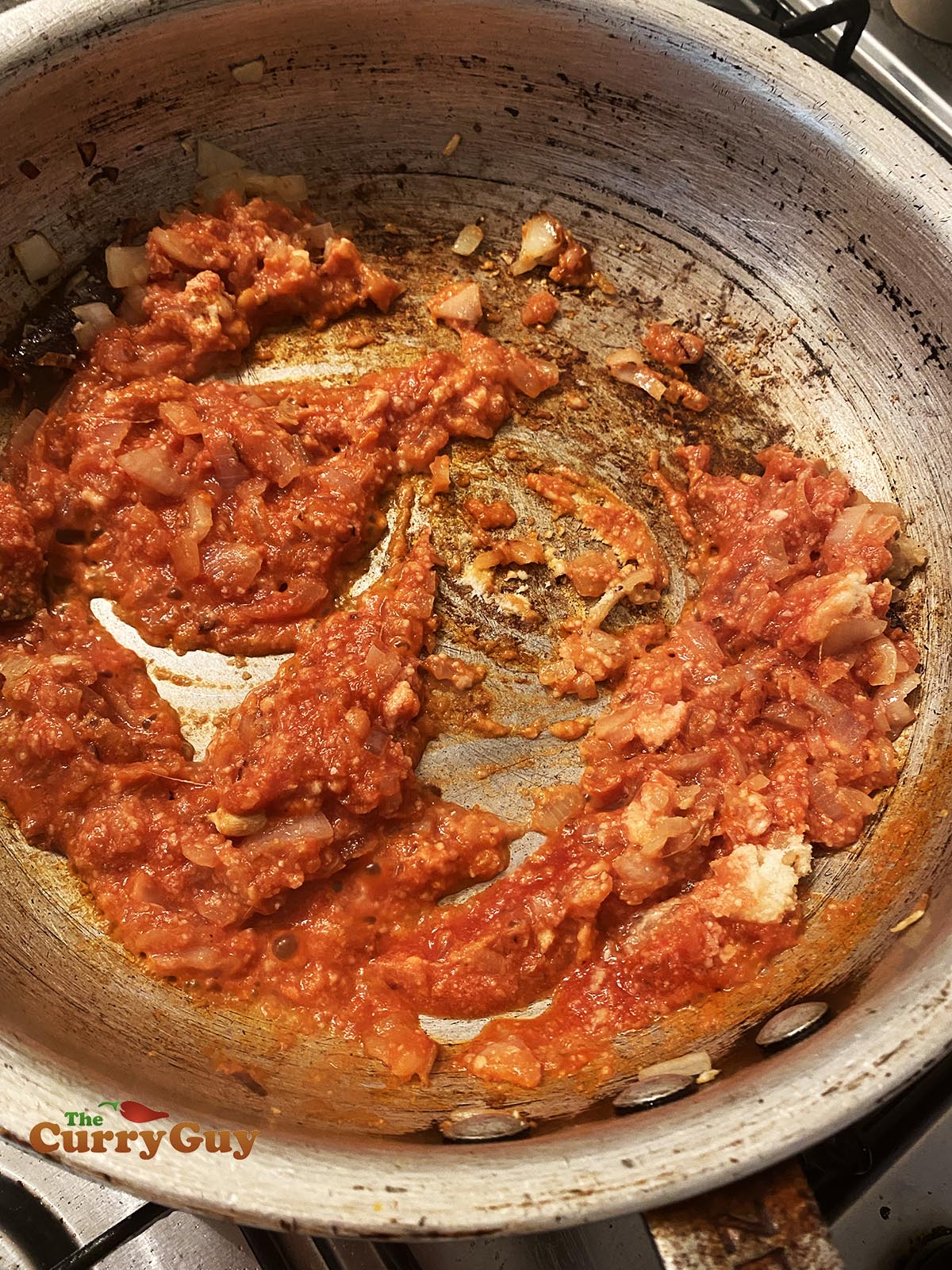 Adding spices, garlic and tomato