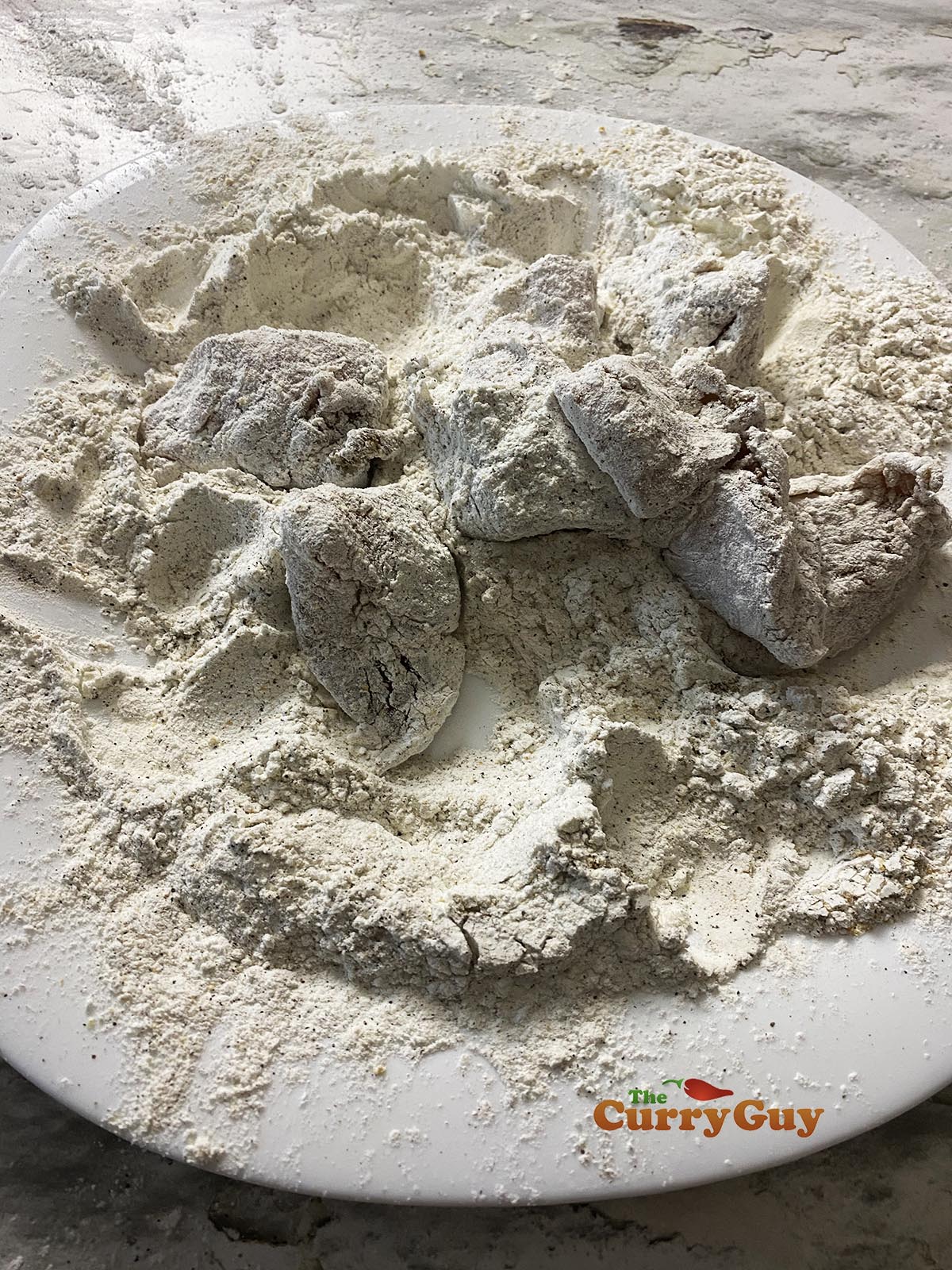 Dusting chicken with flour