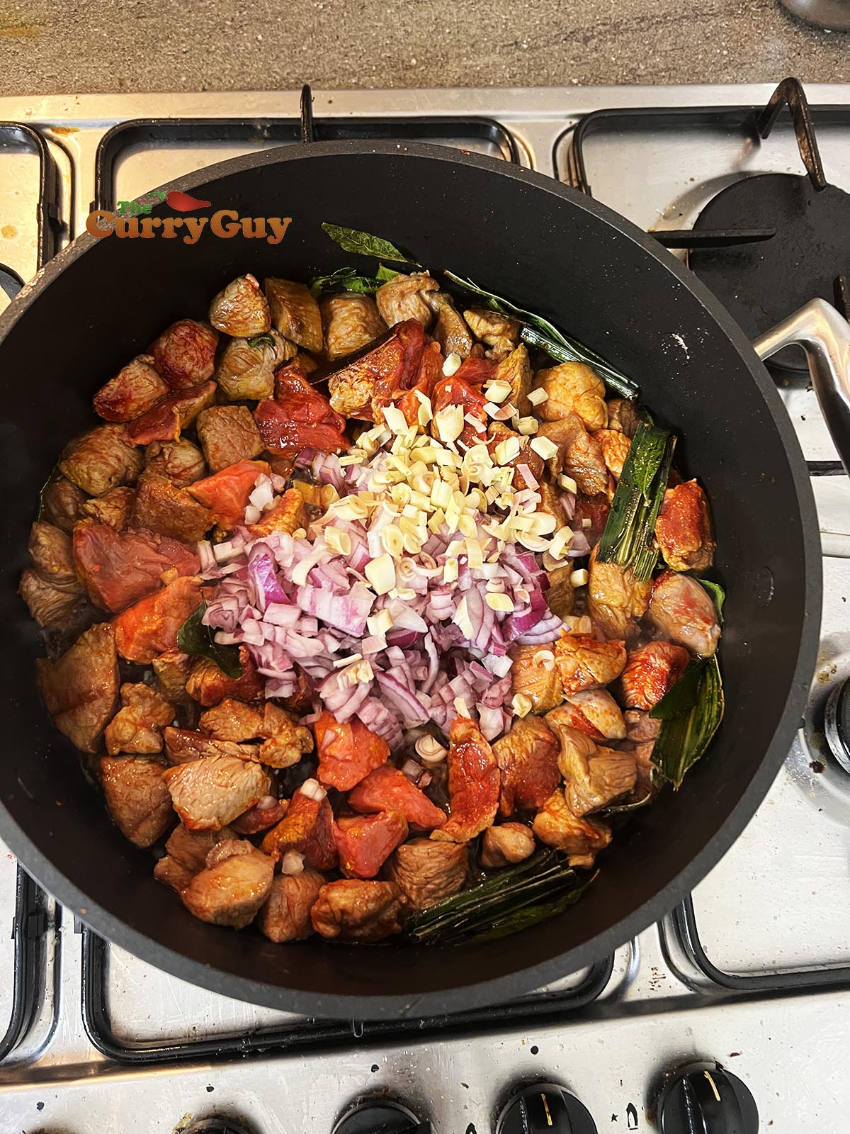Frying onion and lemongrass into the sauce.