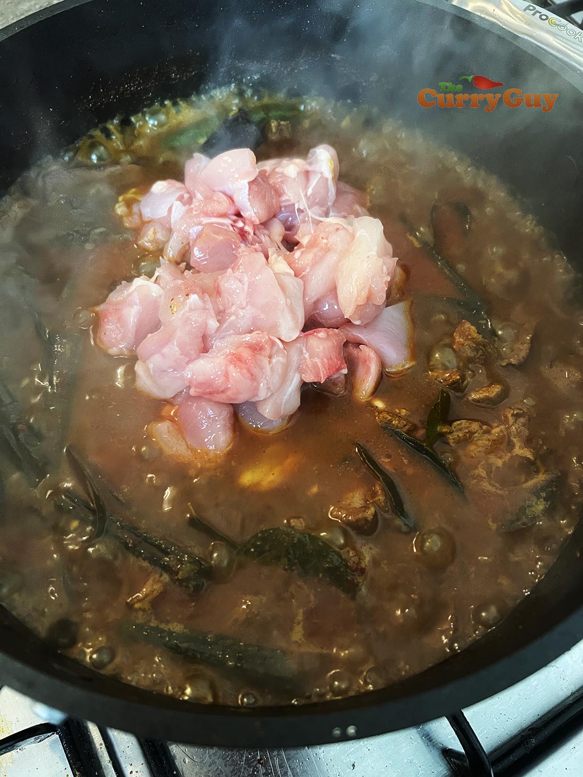 Adding chicken to pan