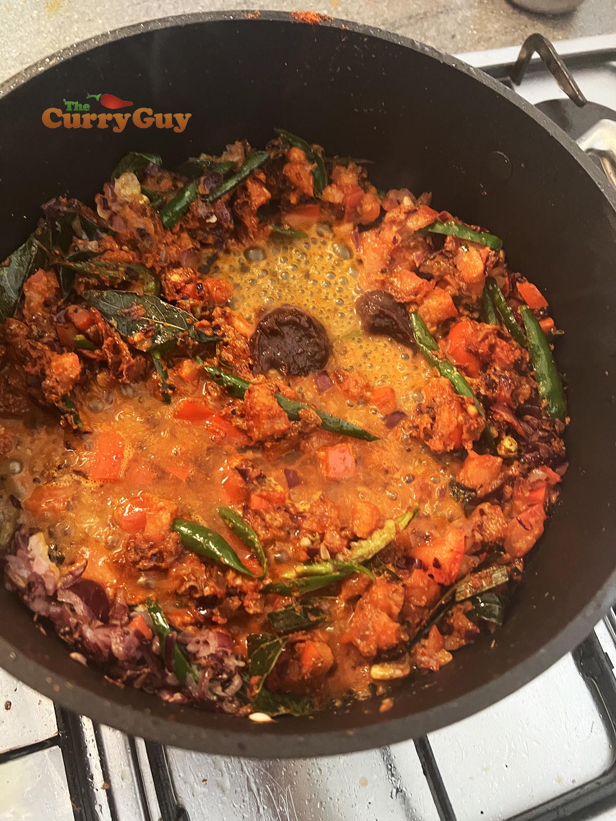 Adding tamarind and vinegar to the pan