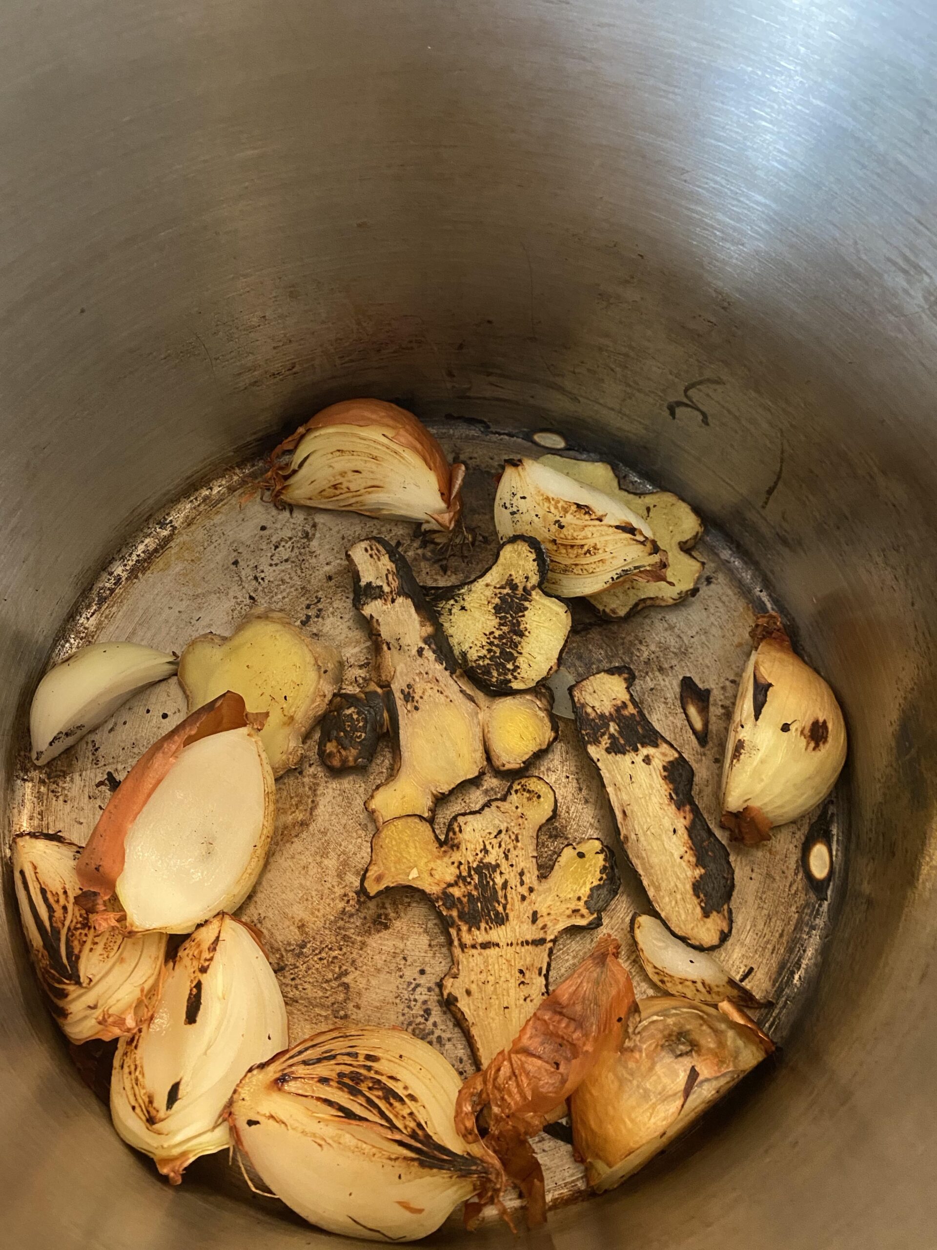 Charring onions and ginger in a pot