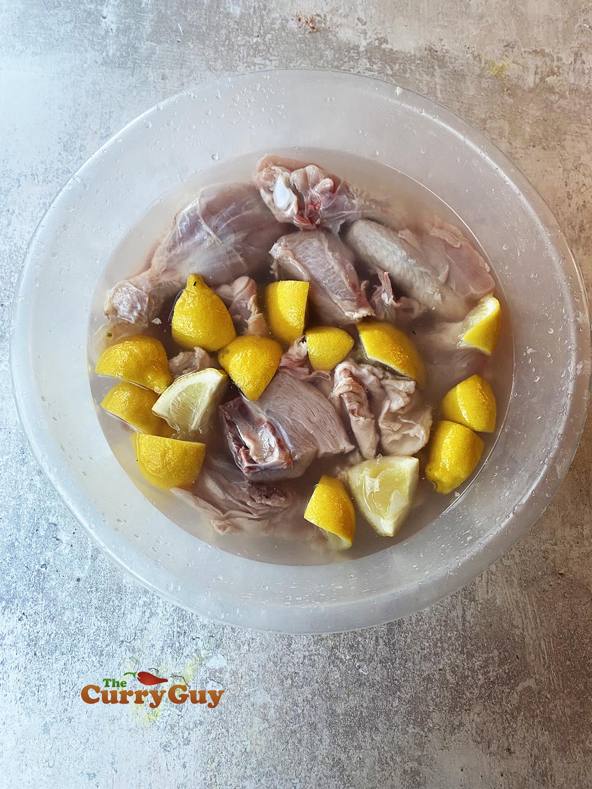 Soaking chicken in water and lemon juice