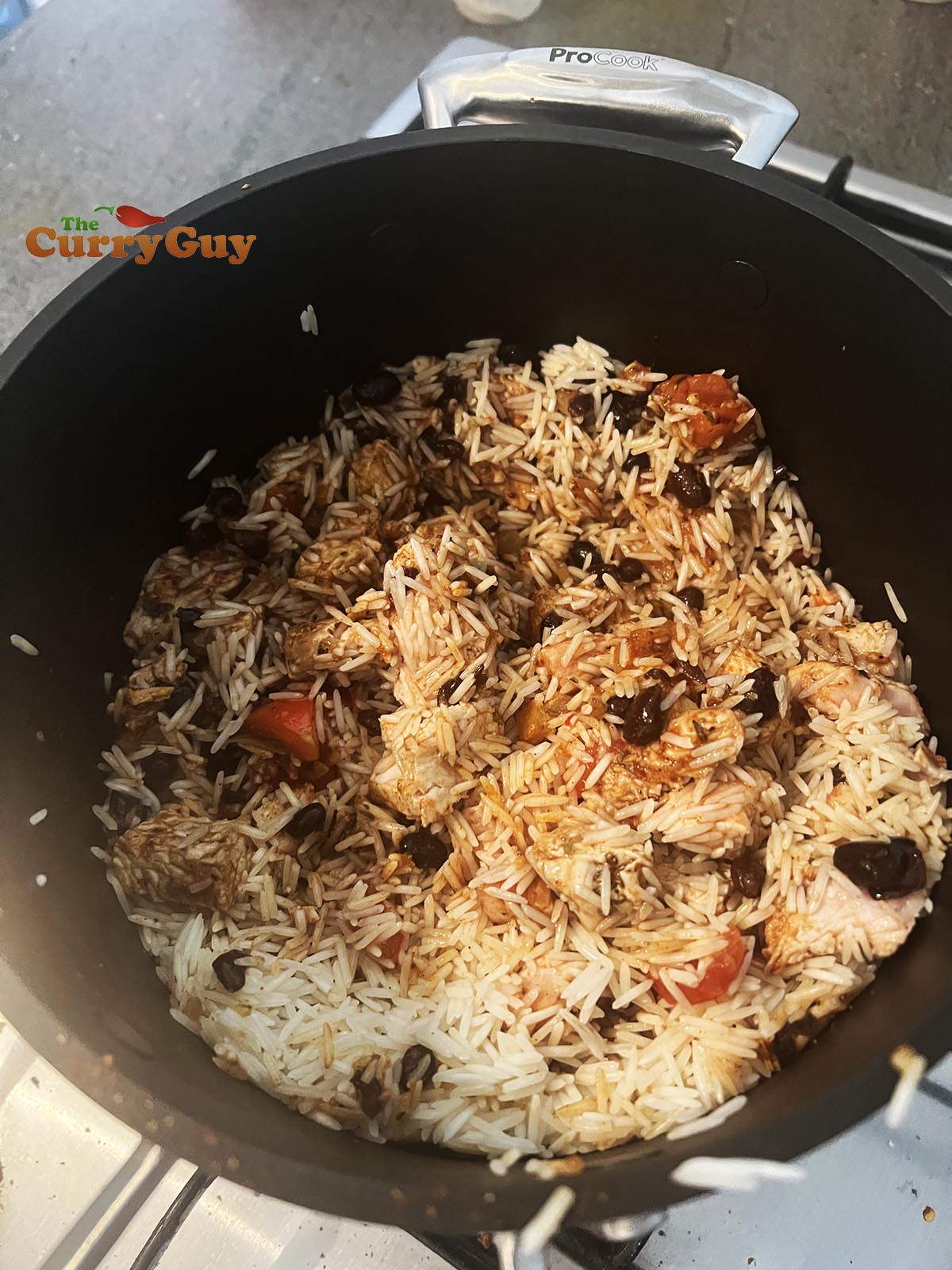 Adding rice and beans to the pan