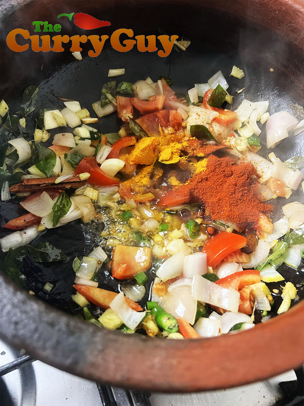 Adding the curry powder, chilli powder and fried coconut/rice
