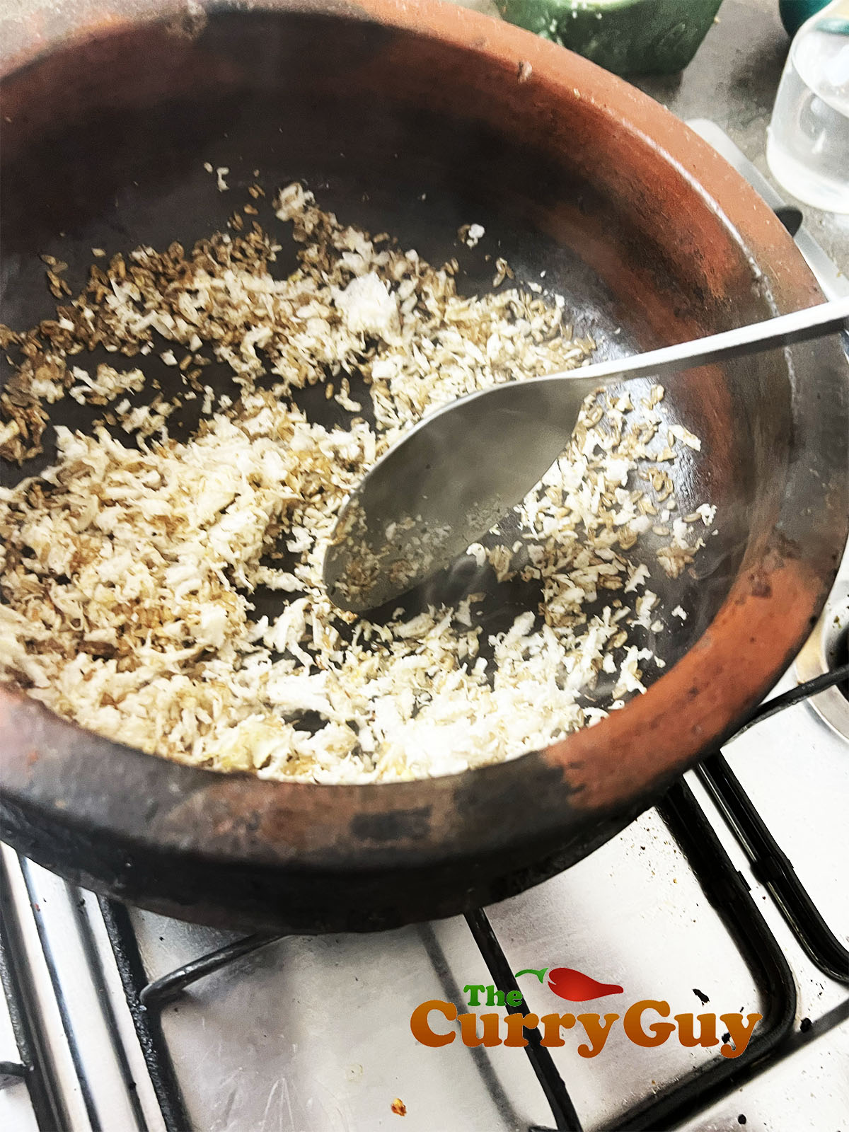 Toasting the raw rice and coconut.