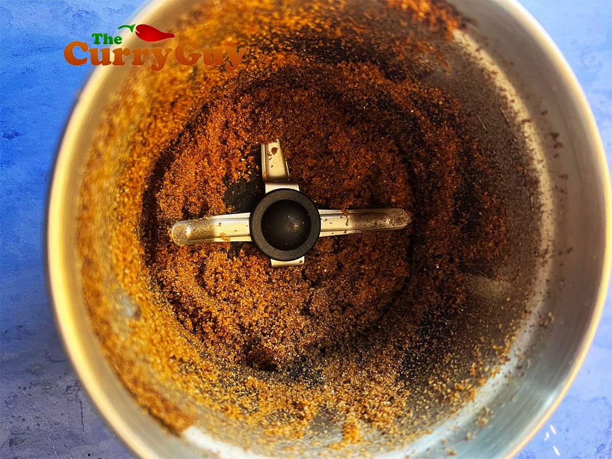 Finely grinding the ground spices.