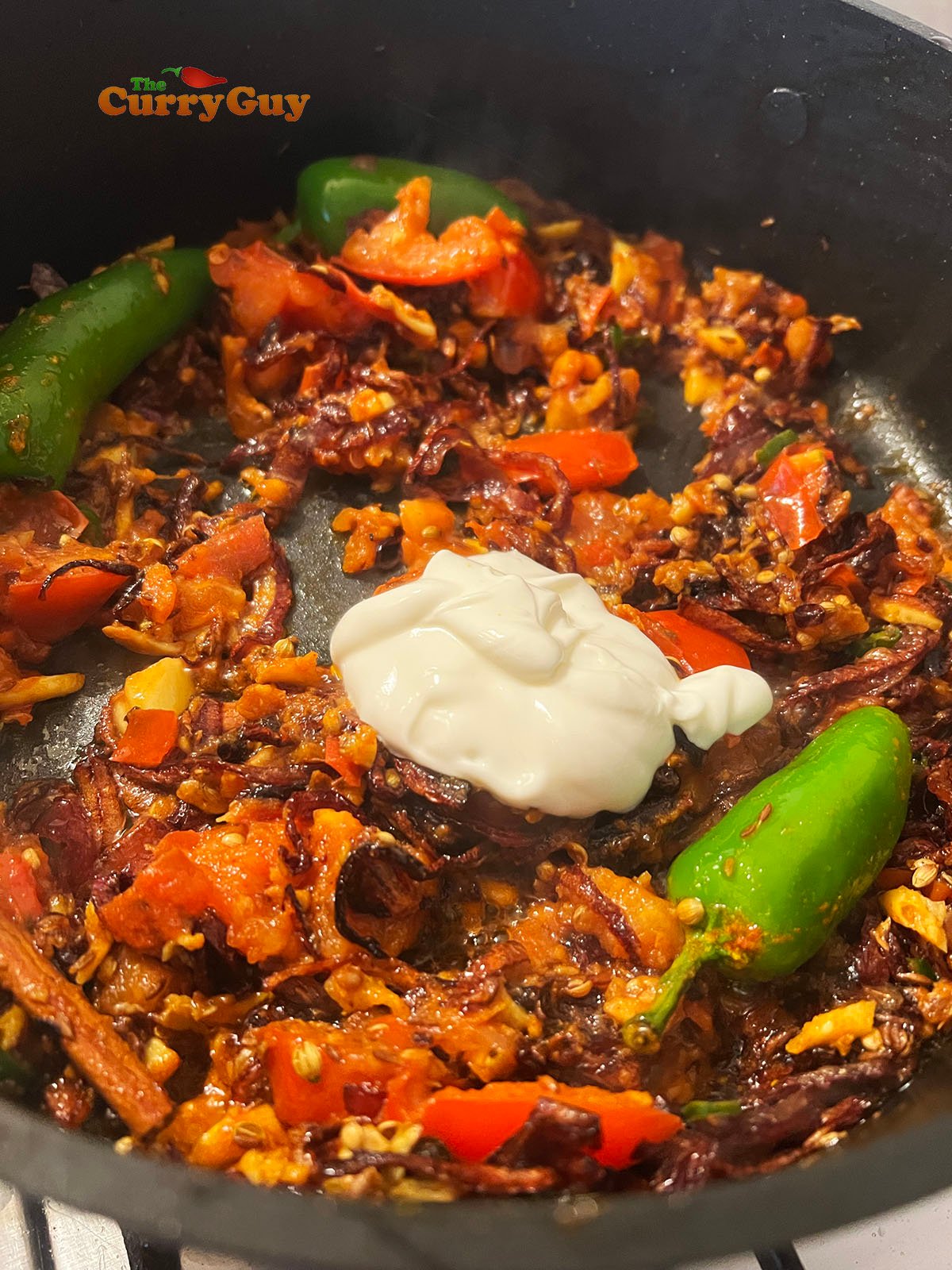 Adding yoghurt to the pan