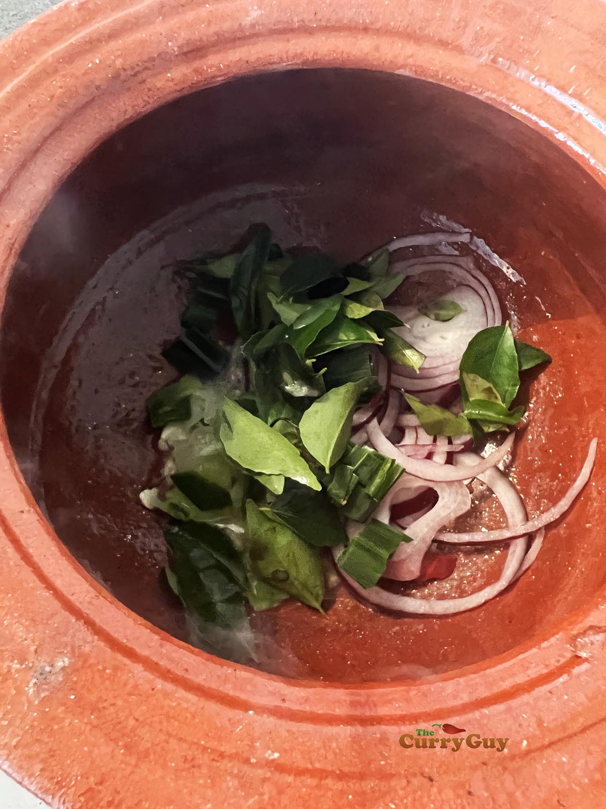 adding veggies to curry