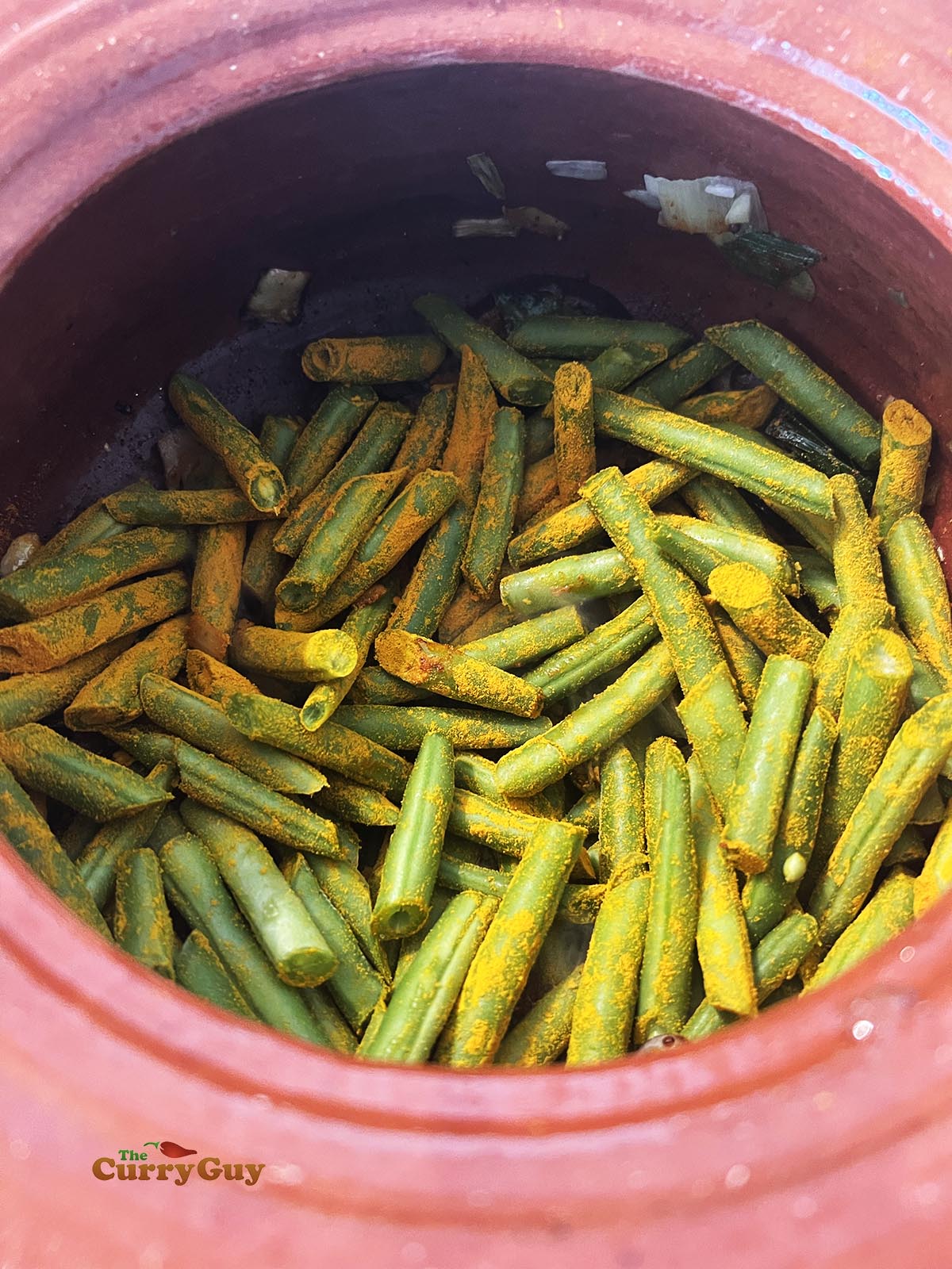 Adding the beans to the curry