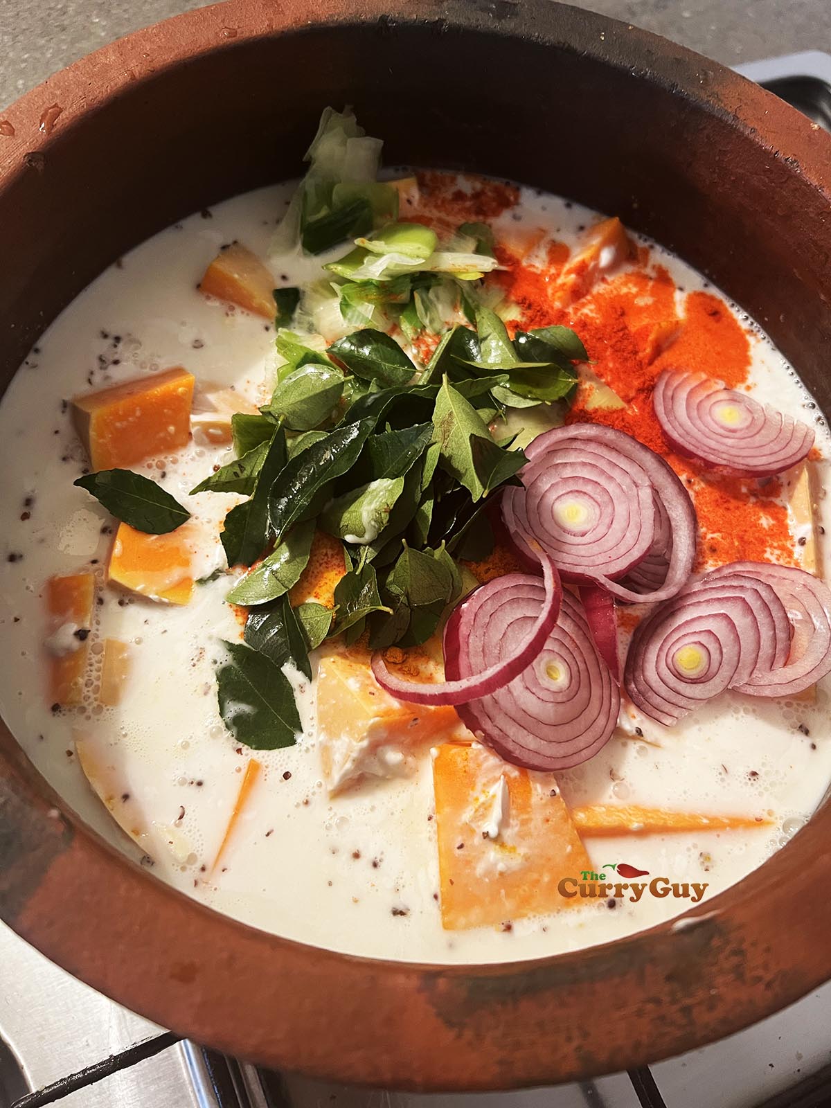 Adding coconut milk to the squash