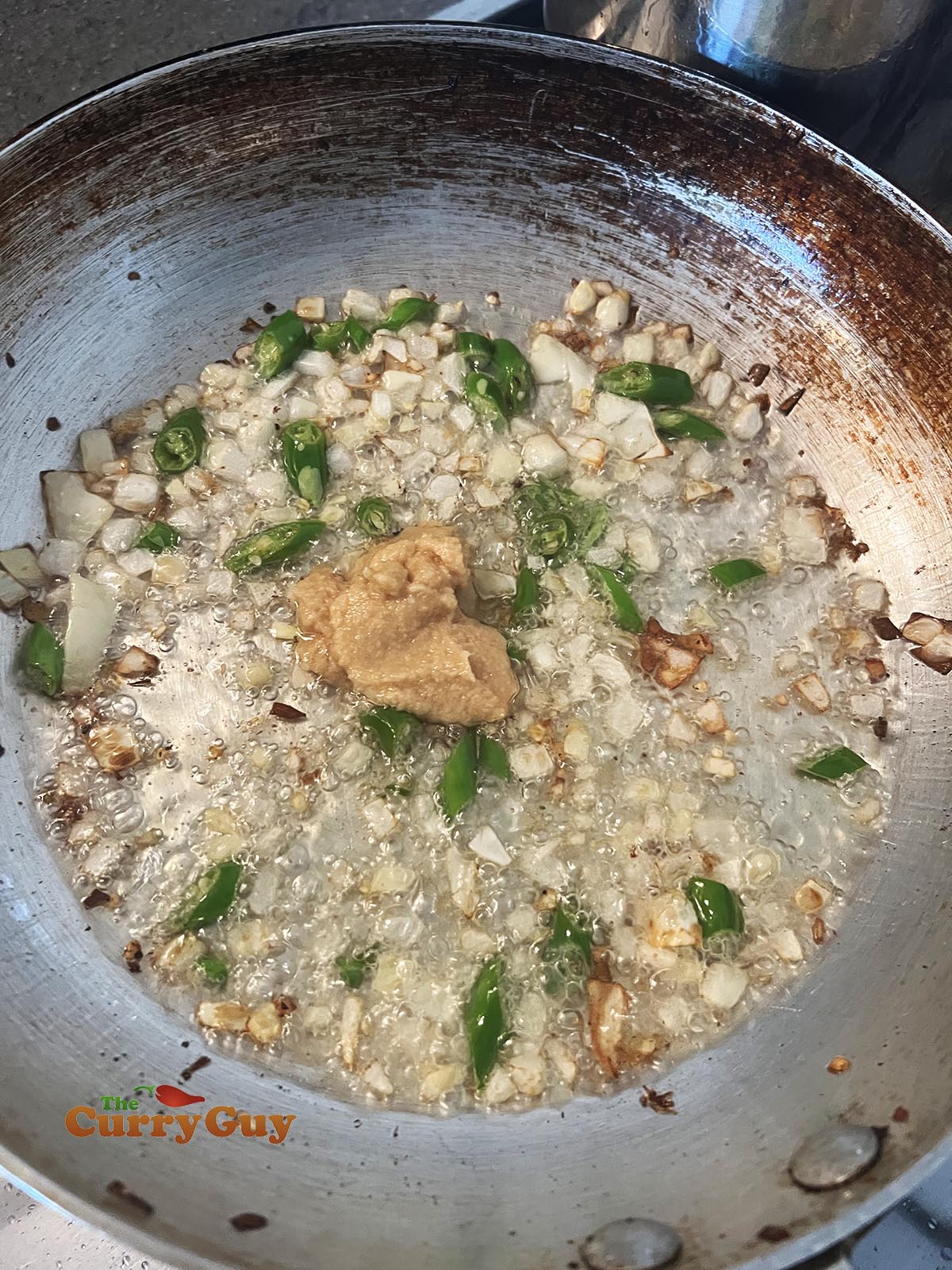 Adding garlic and ginger paste to the pan